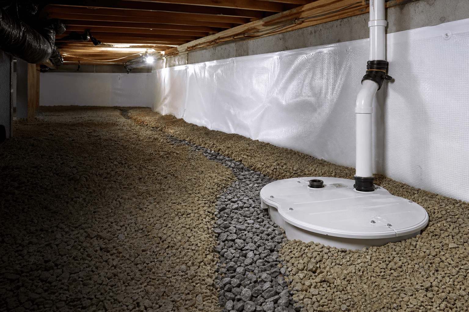 Sump pump and French drain channel installed in an encapsulated crawl space
