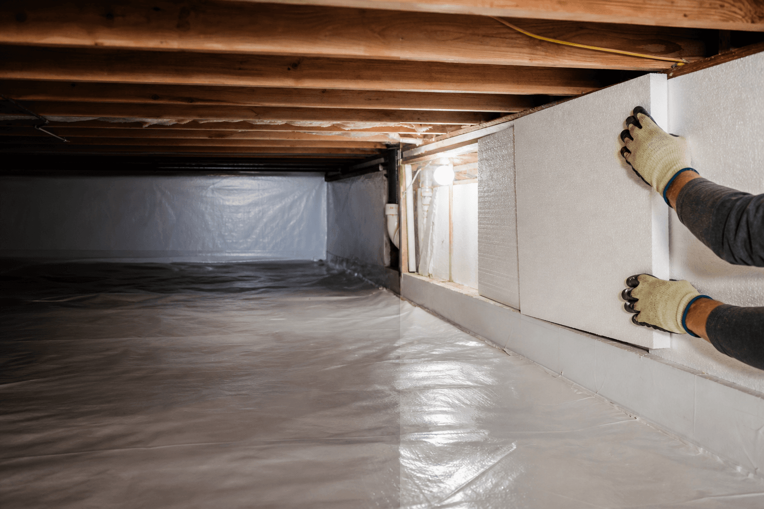 Rim joist insulation installed along the walls of an encapsulated crawl space